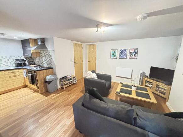 A spacious, modern living room featuring comfor...