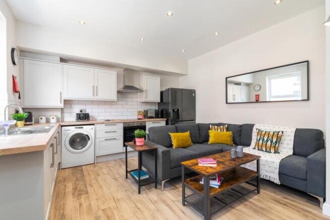 Bright, modern open-plan living area with a com...