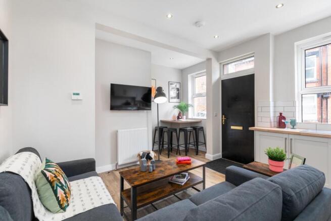 Bright, modern living room with comfortable sea...