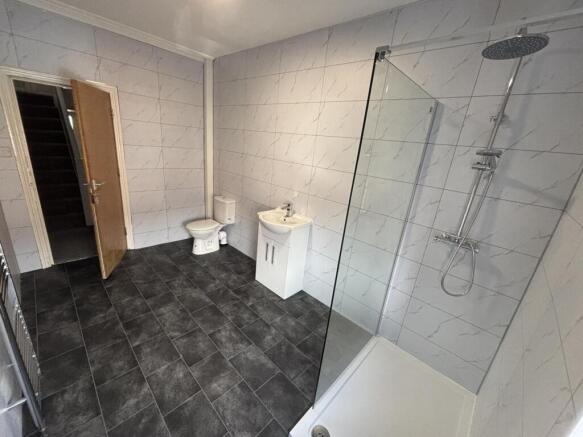 Bright, modern bathroom with large walk-in show...