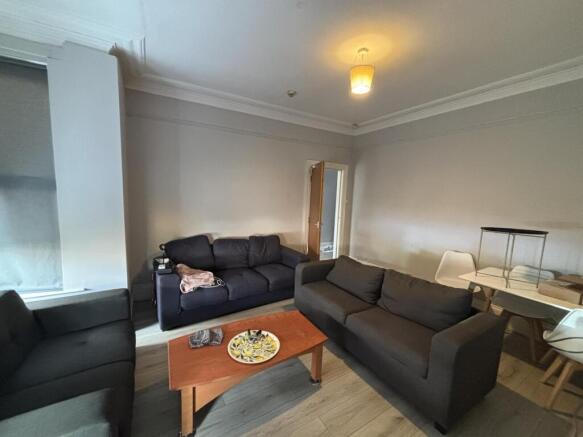 Spacious, modern living room with comfortable m...
