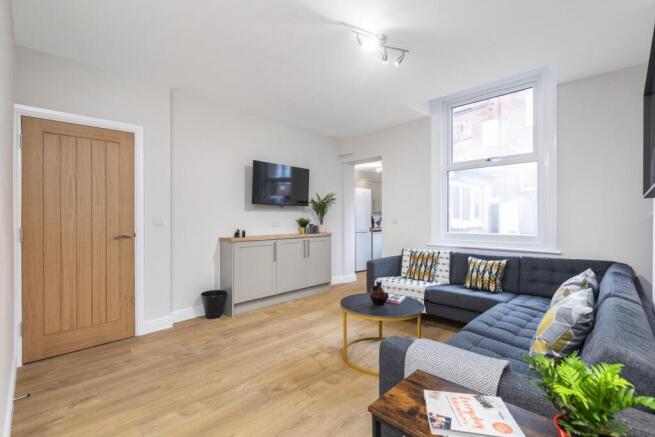 Bright, modern living room with a large L-shape...