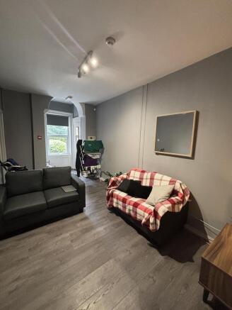 A bright and inviting living room featuring com...