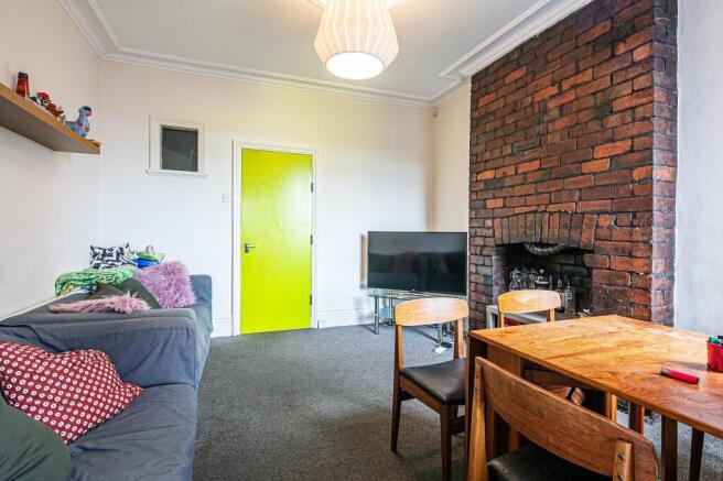 Bright, characterful living room with exposed b...