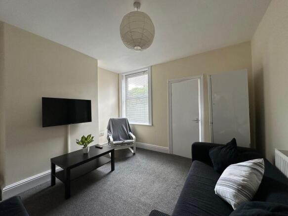 Well-presented living room with a wall-mounted ...