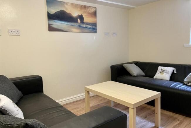 Comfortable communal lounge with two black leat...