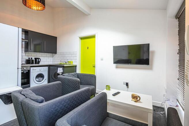 Bright, modern open-plan living area with a com...