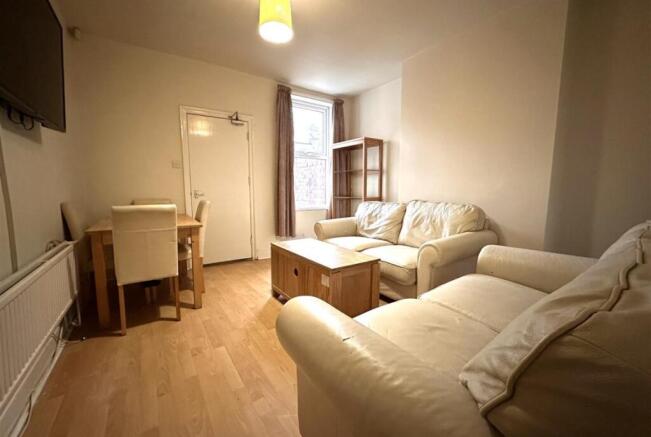 Bright, neutrally decorated living room with cr...