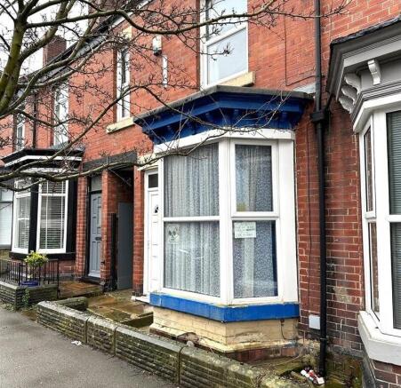 Victorian-style red-brick terraced house with a...