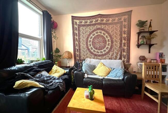 Cosy living room with two black leather sofas, ...
