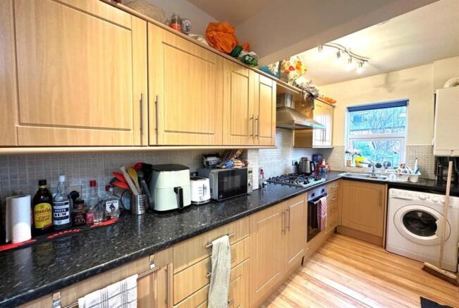 Bright, well-equipped galley kitchen with light...