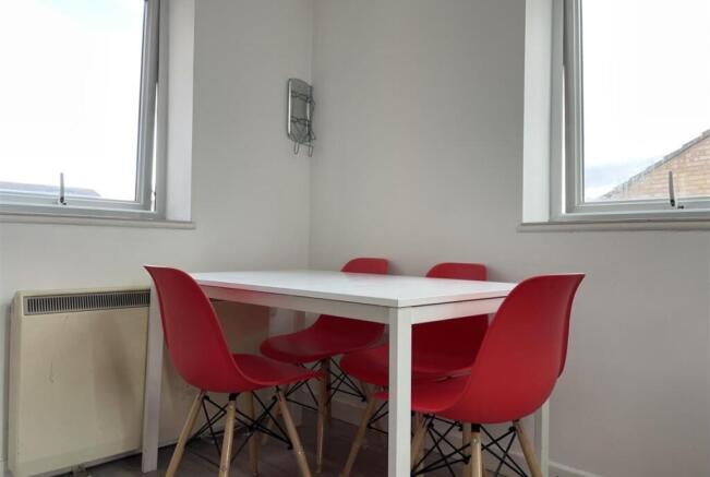 Bright, minimal dining nook with a white table ...