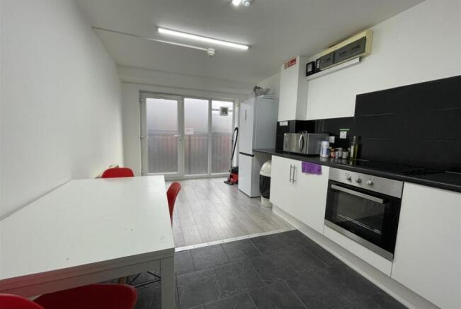 Bright modern kitchen with integrated oven, fri...
