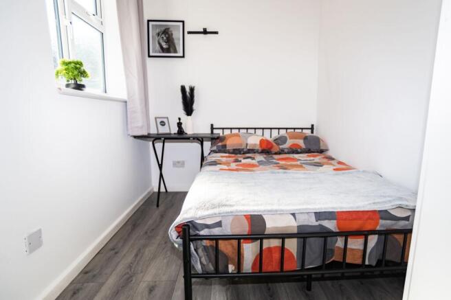 Bright, neatly presented bedroom with a double ...