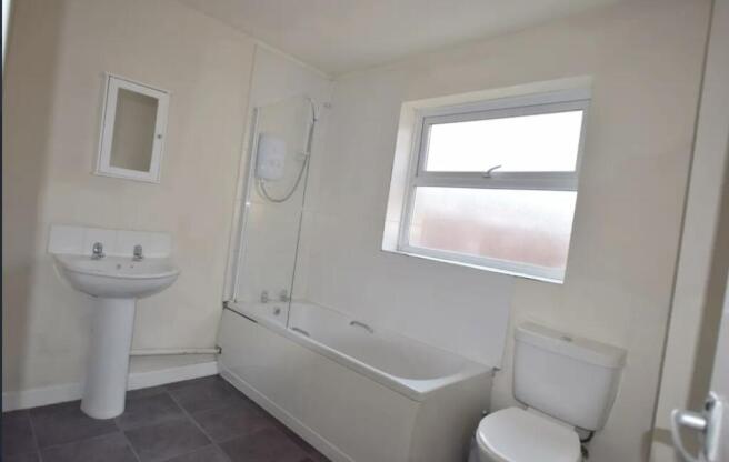 Bright, neutral bathroom with a full bathtub an...