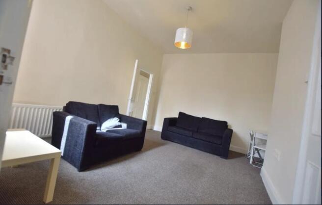 Bright, neutrally decorated living room with tw...