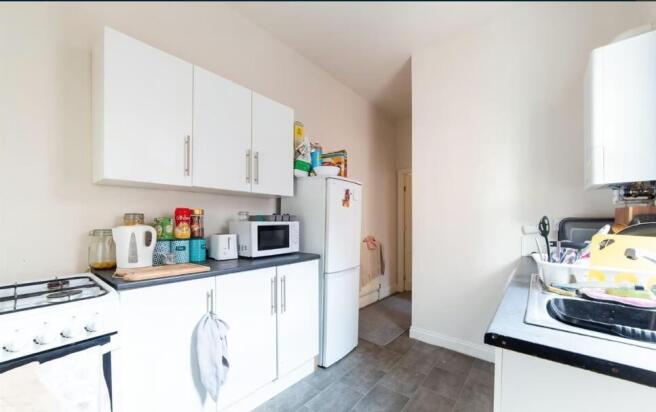 Bright, tidy kitchen with white cabinetry, free...