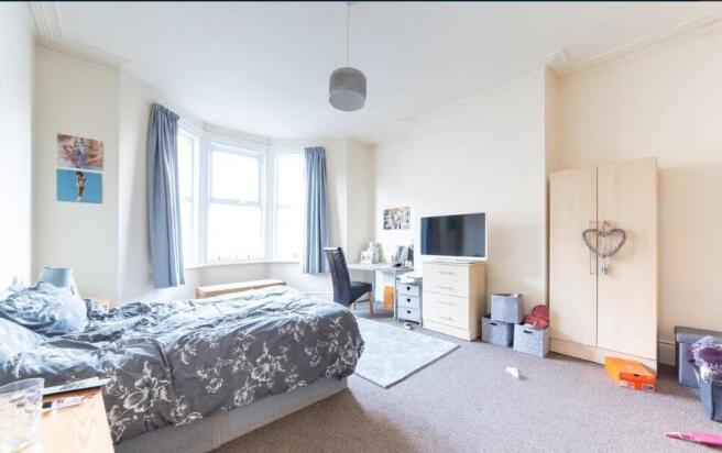 Bright, well-lit double bedroom with a bay wind...