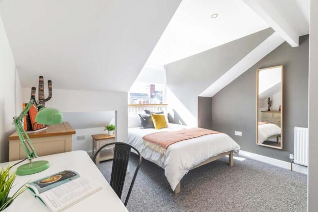 Bright, modern attic double bedroom with sloped...