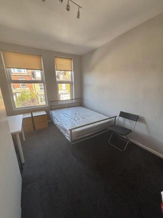 A bright, neatly maintained bedroom featuring t...