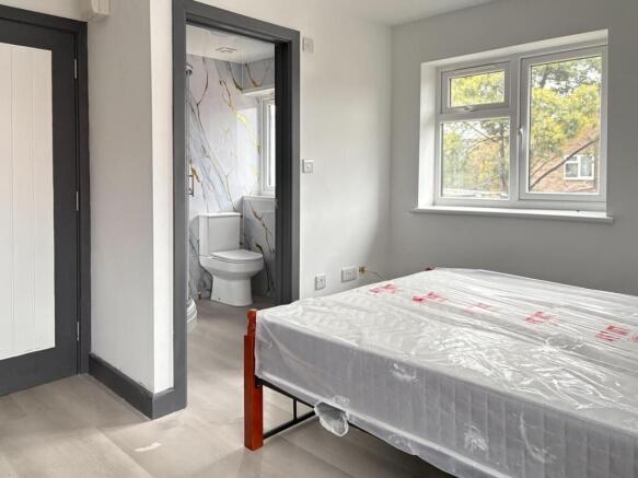 Bright, well-presented bedroom with a large win...