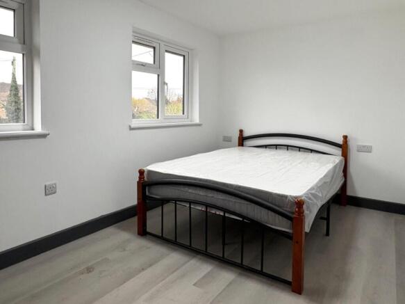 Bright, simply styled bedroom with a double bed...