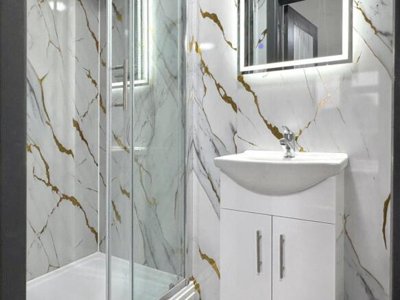 Contemporary bathroom with marble-effect wall t...