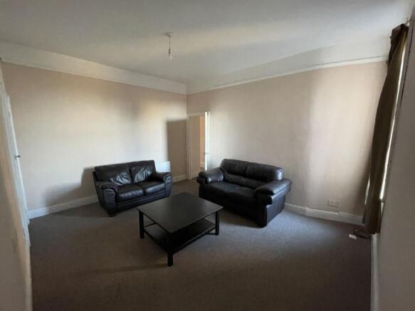 Spacious living room with two leather sofas, ce...