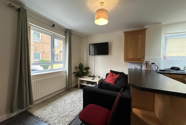 Bright, tidy open-plan living area with large f...