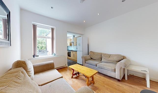 Bright, unfurnished living room with two comfor...