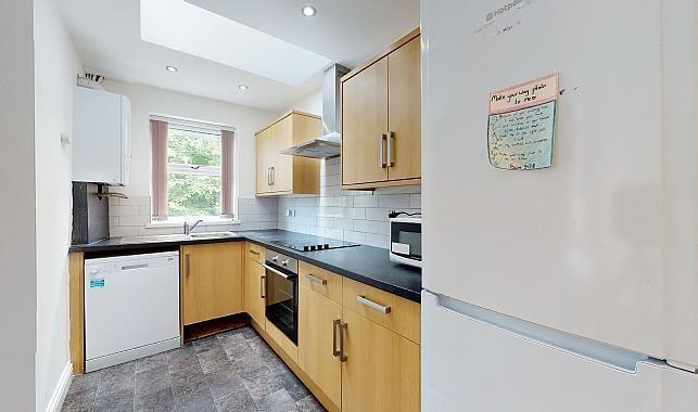 Bright modern galley kitchen with wooden cabine...