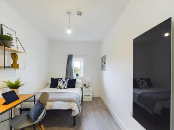 A bright and inviting double bedroom featuring ...