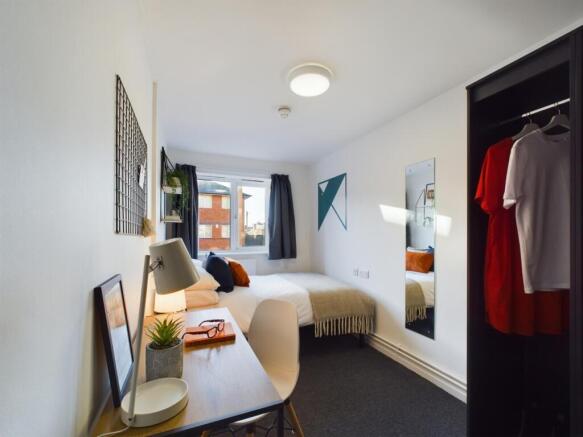 A bright and stylish double bedroom with ample ...