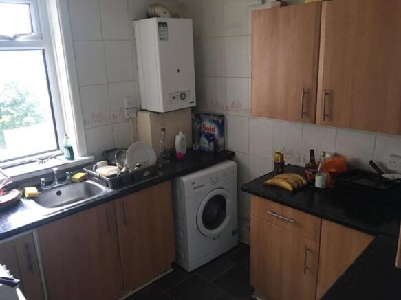 Bright kitchen featuring modern cabinetry, ampl...