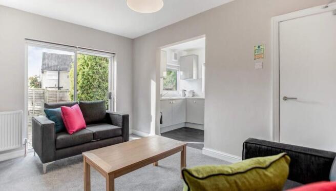 Bright, modern living room with a comfortable t...