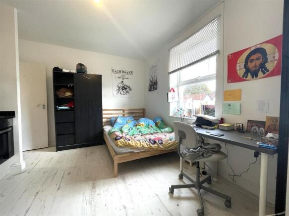 Bright double bedroom with a large window, simp...