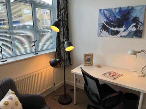Bright, tidy study corner with a large window, ...