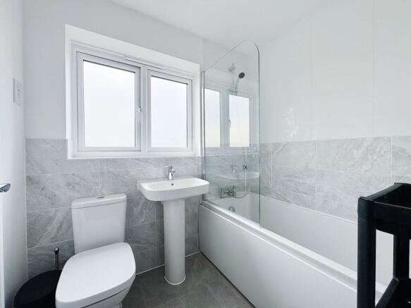 Bright, modern bathroom with a clean white suit...