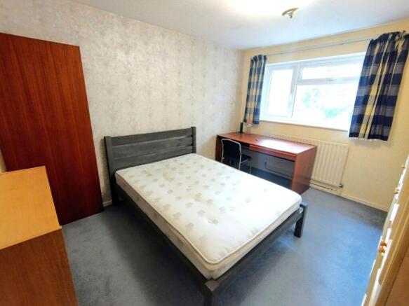 Bright furnished bedroom with a double bed fram...