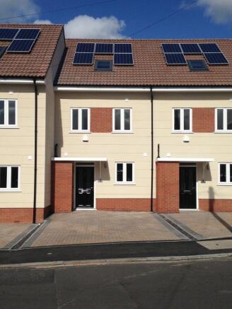 Modern terraced house with neat brick and cream...