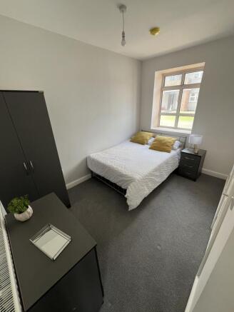 Bright, simply furnished double bedroom with a ...