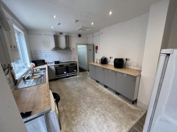 Spacious communal kitchen with long worktops, t...