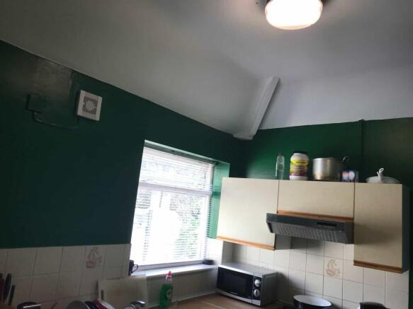 A functional kitchen with a window providing na...