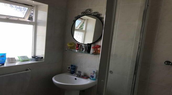 A neat bathroom featuring a white sink with a r...
