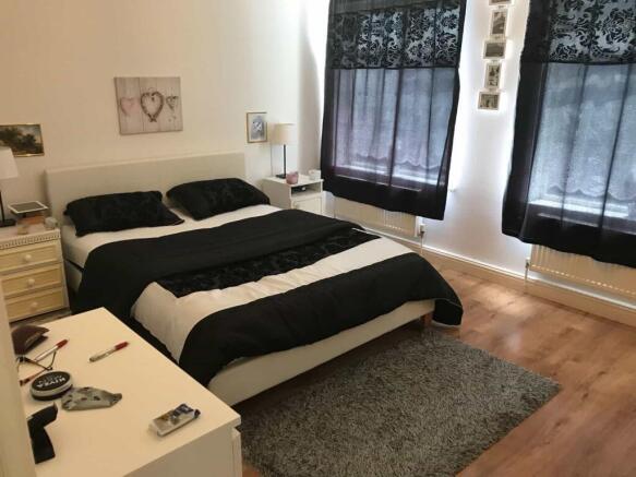 A stylish double bedroom featuring a comfortabl...