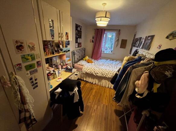 Bright, cosy bedroom with a double bed by the w...