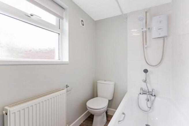 A stylish and modern bathroom featuring a sleek...