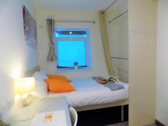 Bright, neatly presented bedroom with a comfort...