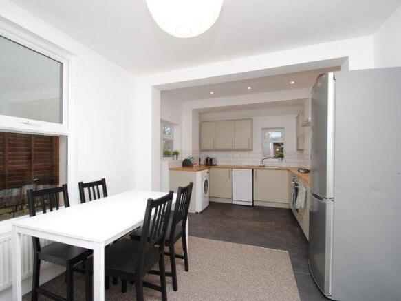 Bright open-plan kitchen and dining area with a...