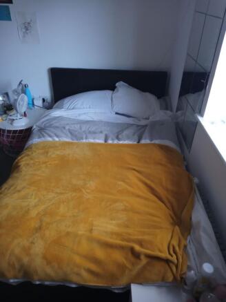 Cozy double bedroom with a comfortable bed dres...